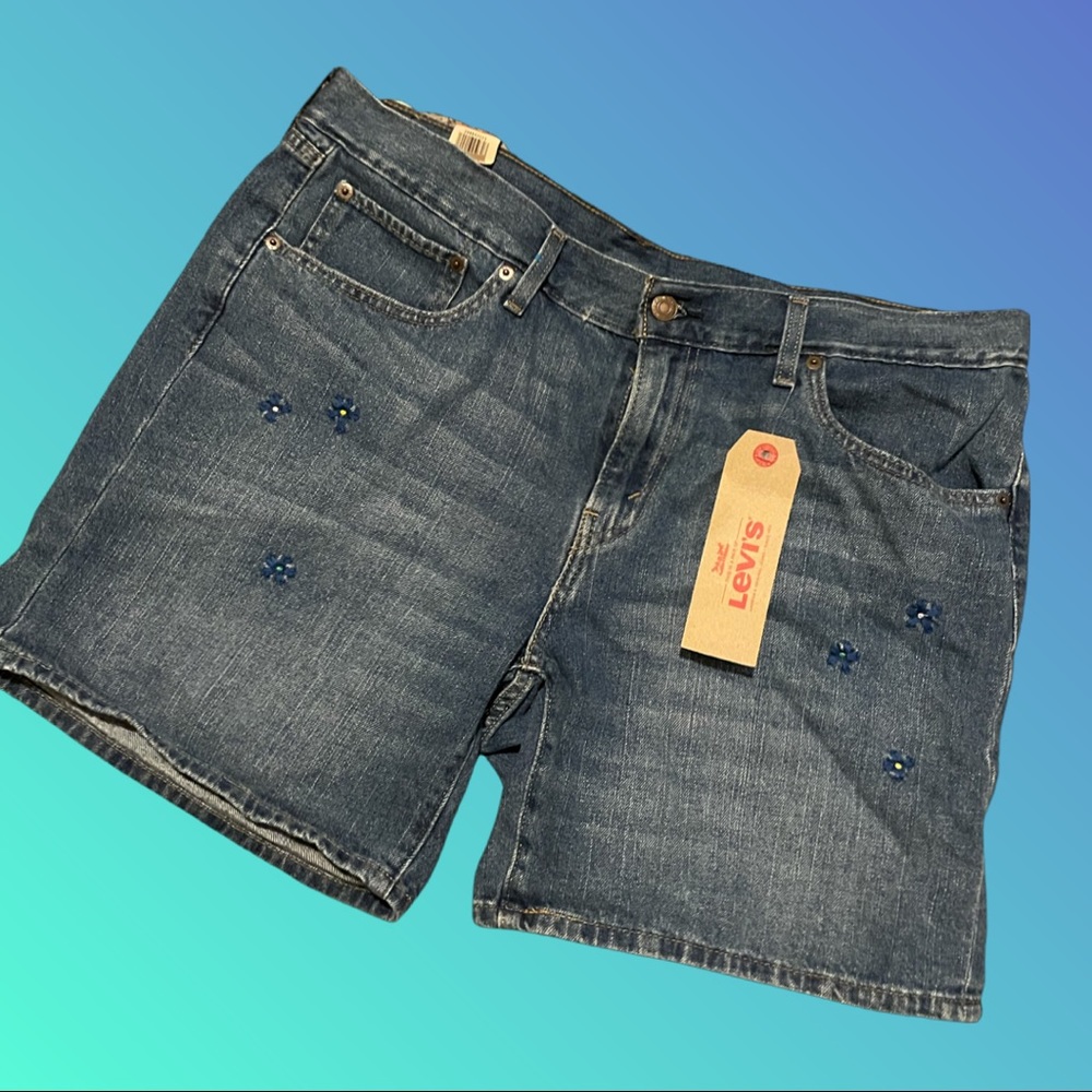 Size 33 Levi Shorts with blue flower details.